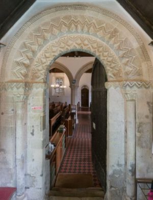 Decorated norman arch over the north door to All Saints Church, Compton